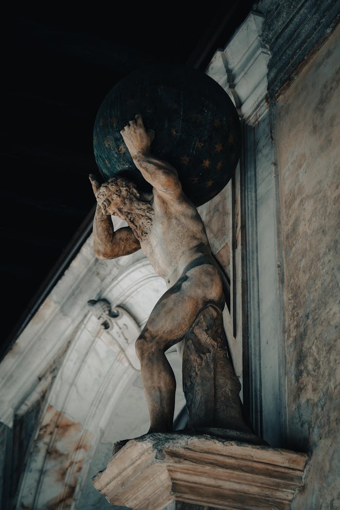 Intricate stone sculpture of Atlas holding the celestial sphere, showcasing classical art.